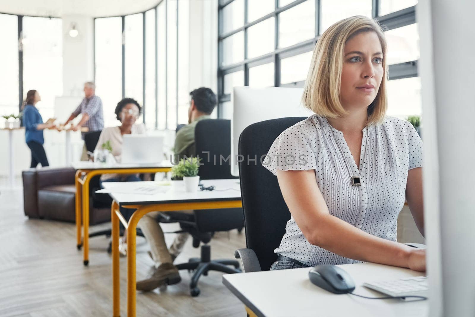 Working on the next big design. a designer working on her computer at her desk