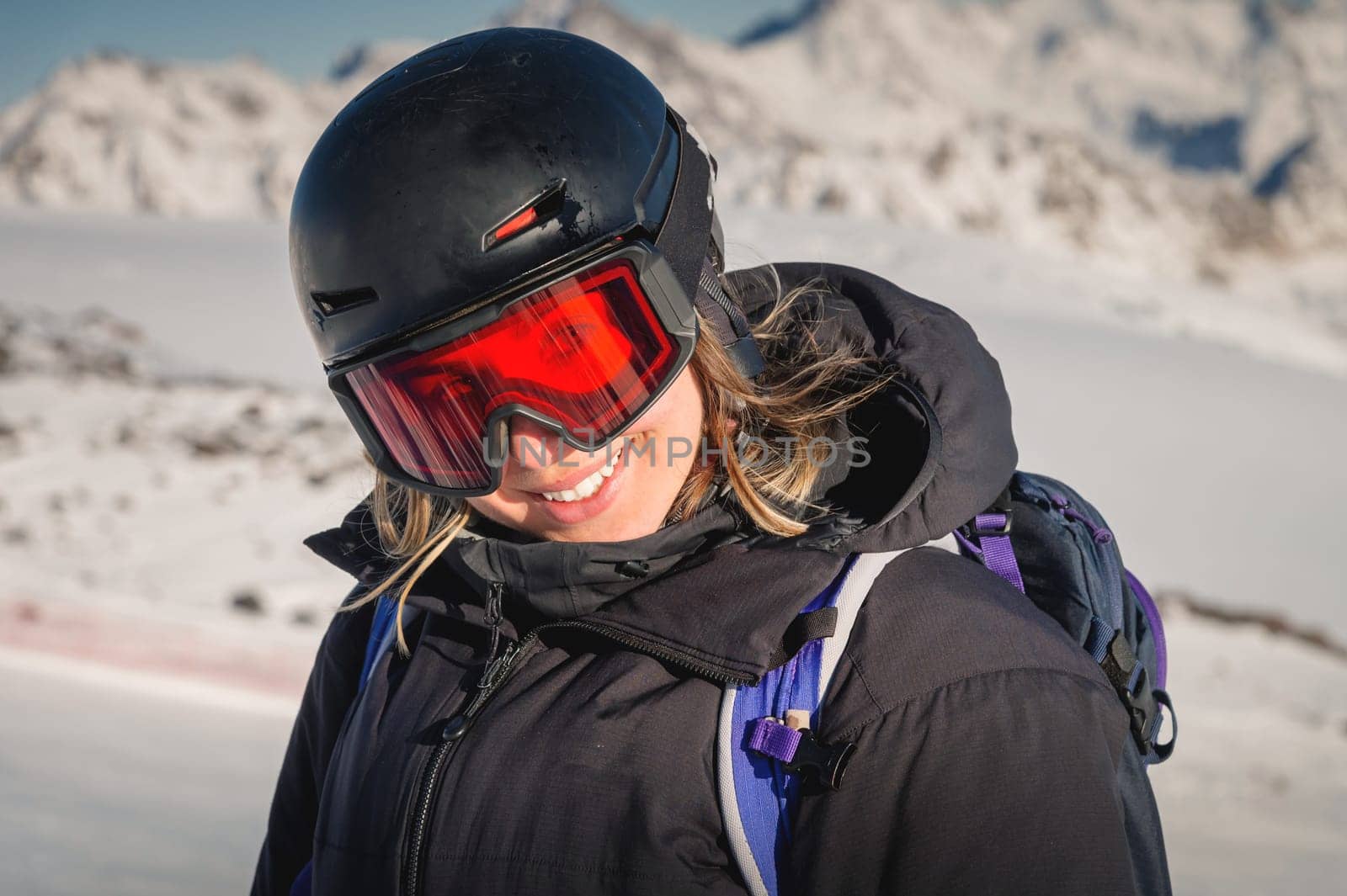 Skier smiling happy cheerful satisfied woman in warm windbreaker jacket ski goggles mask glasses spend extreme weekend in mountains on resort by yanik88