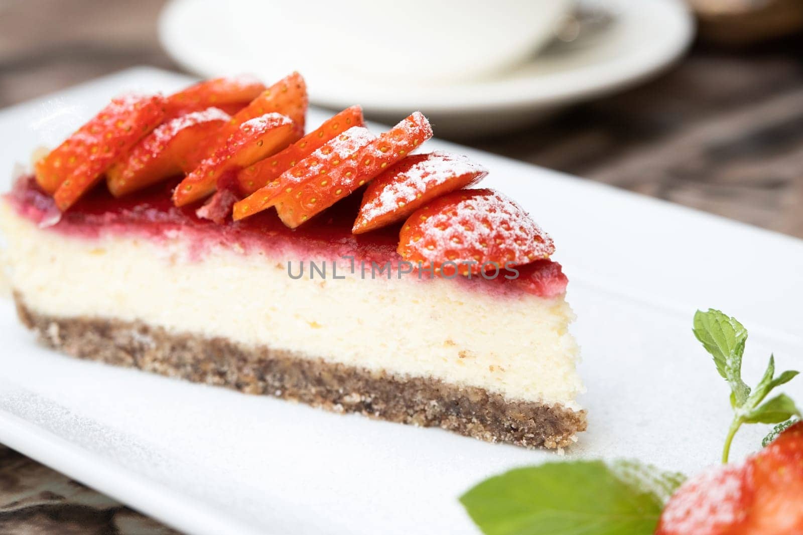 Piece of delicious cheesecake with berries on table close up by Desperada