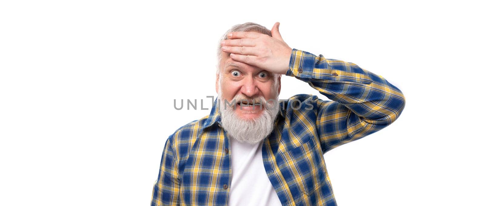 smiling 50s mid aged grey-haired man with beard holding his head against white background.