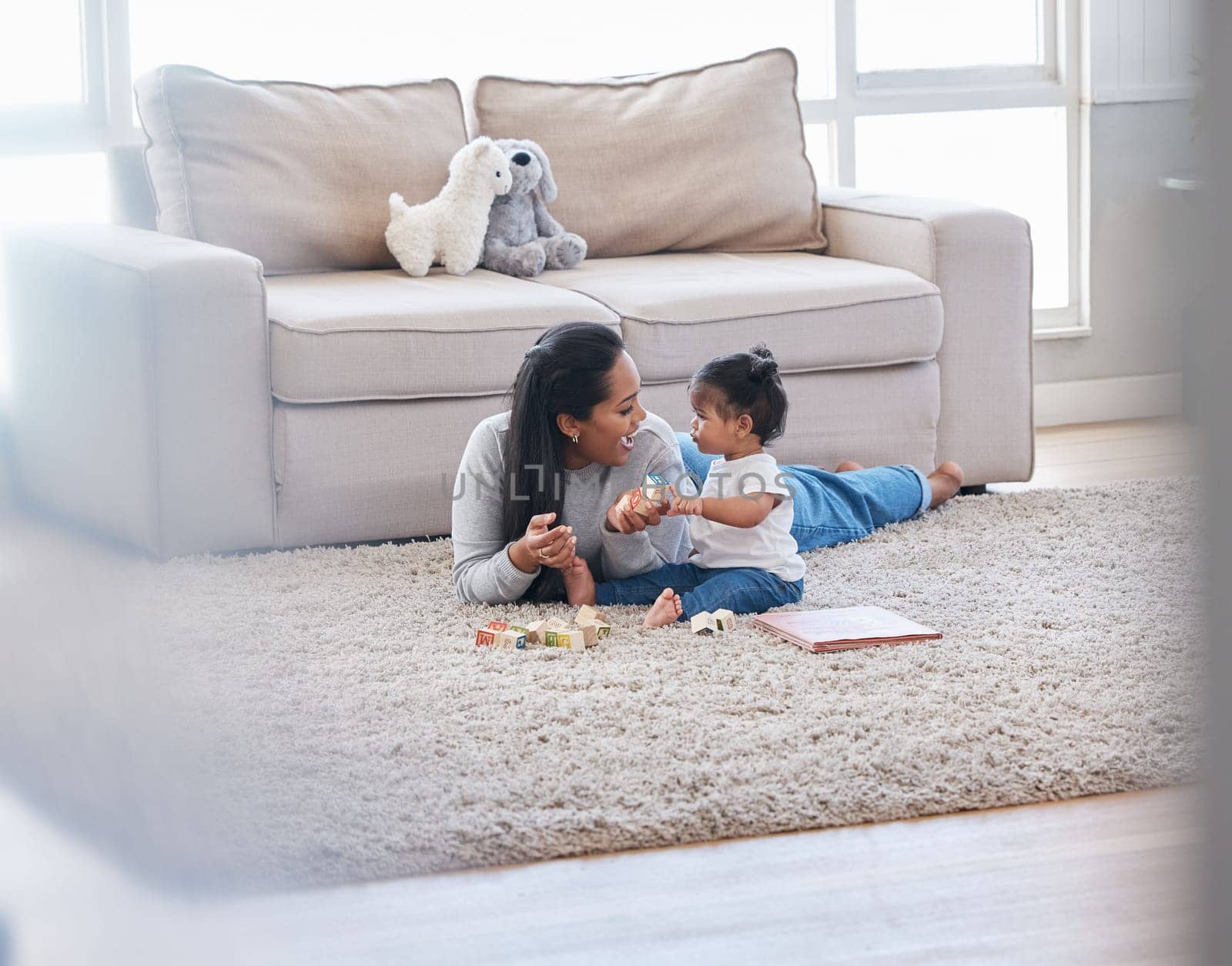 Baby, mom and living room fun of a mother and kid with toys for knowledge development. Smile, happiness and parent care on a lounge rug in a home with mama love and bonding together with a child.