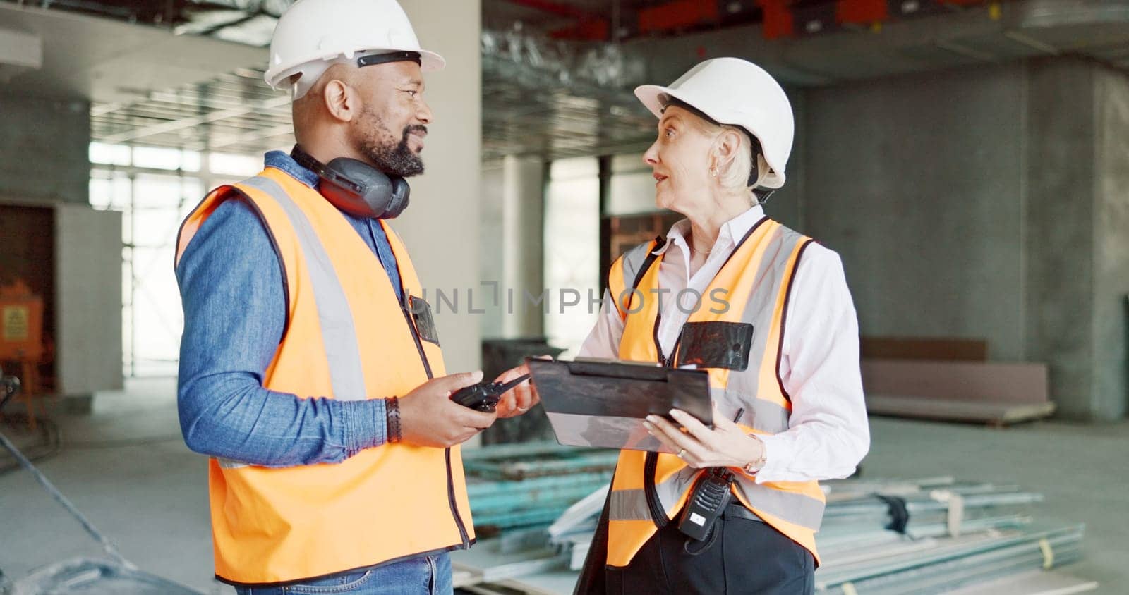 Construction, inspection and clipboard, black man and woman discussion, construction site with scaffolding and building renovation checklist. Contractor with inspector, engineering and communication. by YuriArcurs