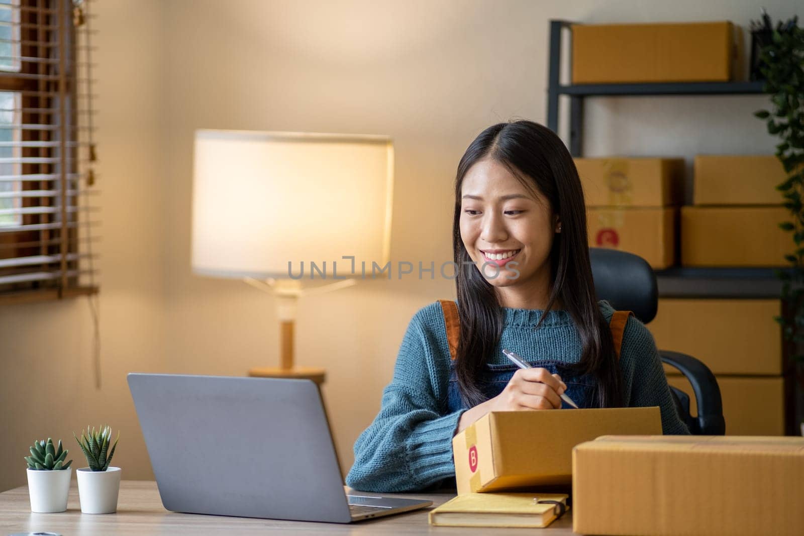 Young Business owner woman teenager working online e-commerce shopping online, Asian business woman selling business online marketing at home. High quality photo