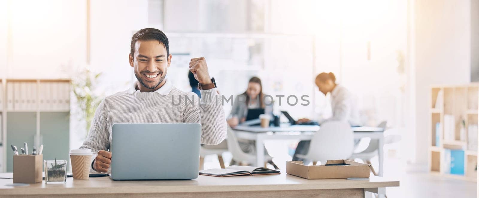 Man, laptop and celebrate at office desk for success, deal or crypto on internet at startup. Winner businessman, computer or smile for winning celebration, bitcoin goal and stock market achievement.