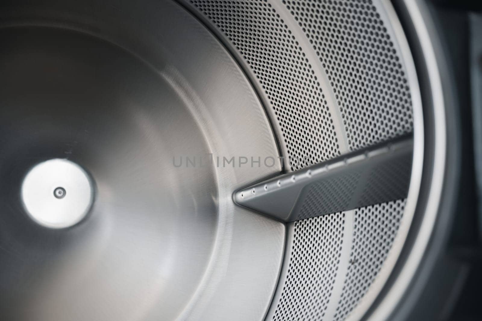 Close up brand new drum material metal electrical household appliance, Inside of washing machine tub is made of stainless steel, Empty inside