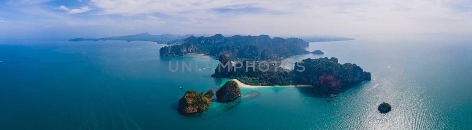 Railay Beach Krabi Thailand, the tropical beach of Railay Krabi, view from a drone of idyllic Railay Beach in Thailand in the evening at susnet with a cloudy sky