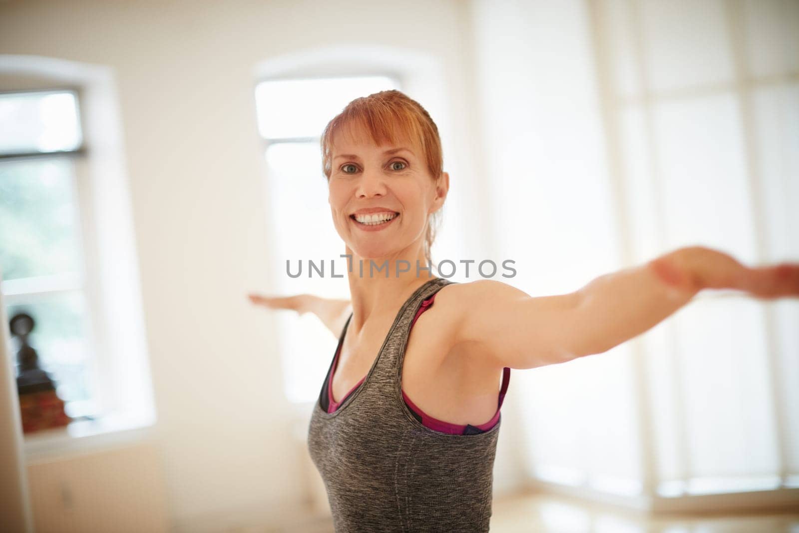 Yoga is my secret for overall wellbeing. a woman doing yoga indoors