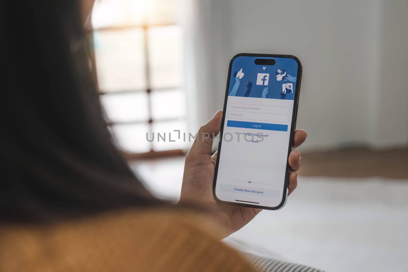 CHIANG MAI, THAILAND - MAY 1, 2023: Facebook social media app logo on log-in, sign-up registration page on mobile app screen on iPhone 14 in person's hand working on e-commerce shopping business..