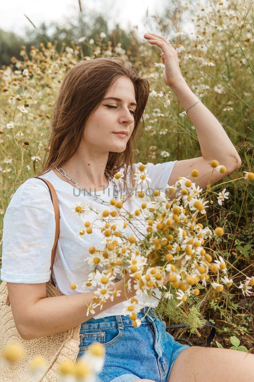 Beautiful young woman in nature with a bouquet of daisies. Field daisies, field of flowers. by Annu1tochka