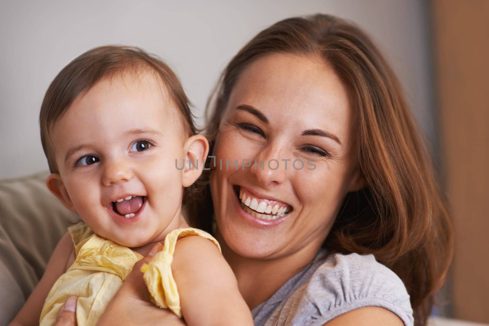 Loving bond. Closeup portrait of a mother and baby daughter laughing. by YuriArcurs