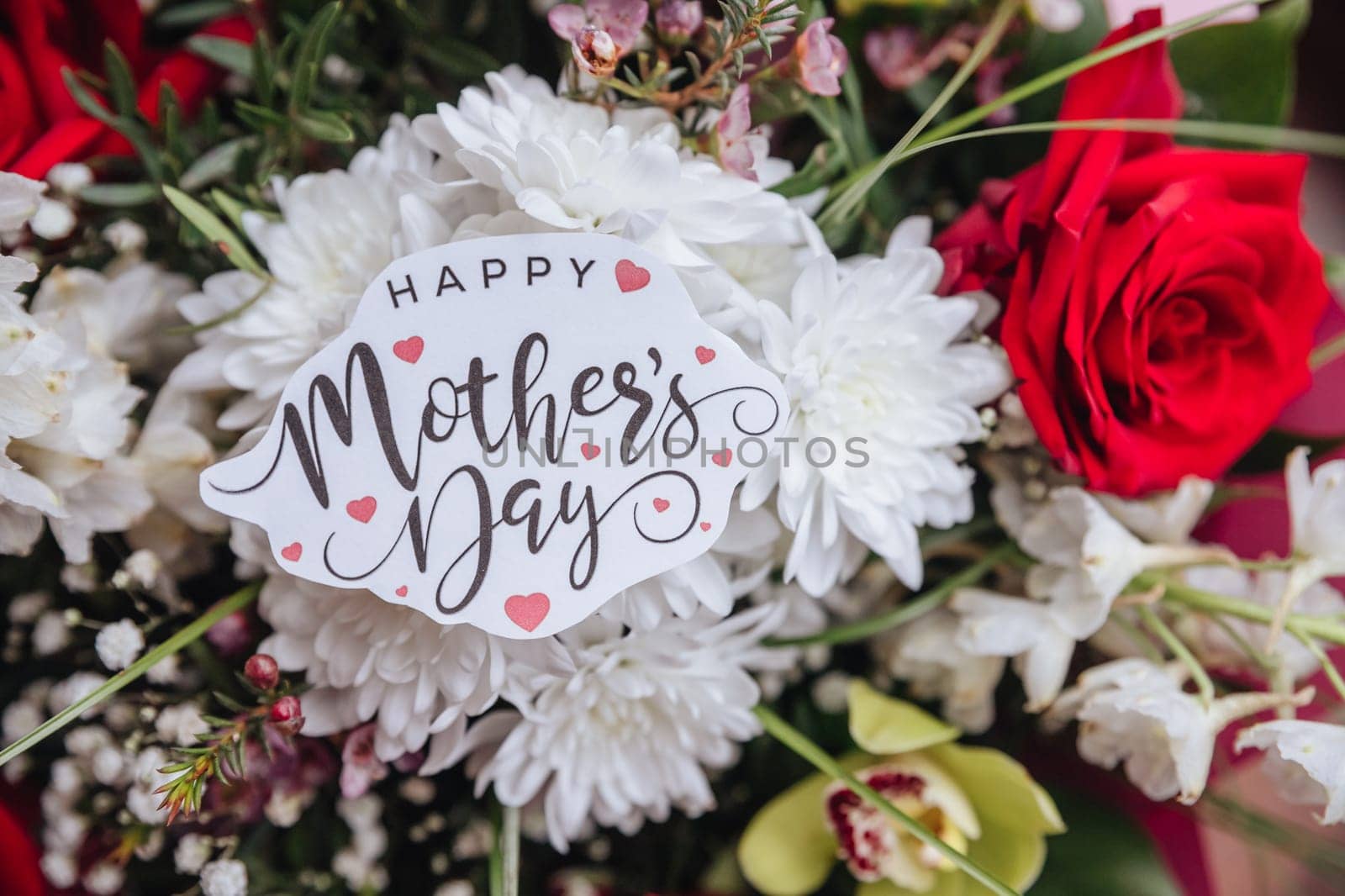 Close up of a beautiful bouquet of roses with a happy mothers day card