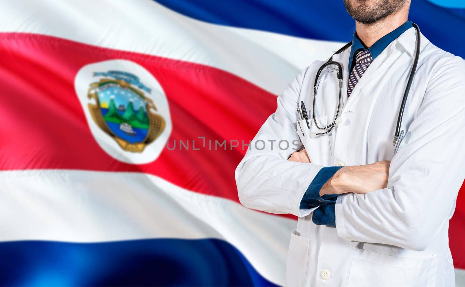 Costa Rica national health concept. Doctor with crossed arms on Costa Rica flag, Health and care with flag of Costa Rica by isaiphoto