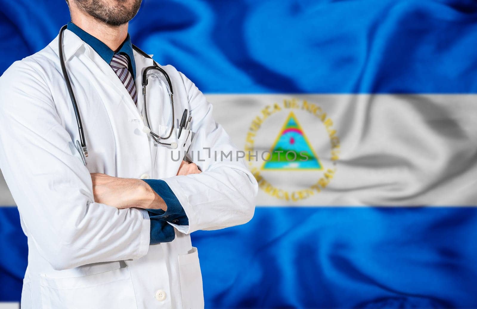 Health and care with the flag of Nicaragua. Nicaragua national health concept, Doctor with stethoscope on Nicaragua flag. Doctor arm holding stethoscope on nicaragua flag