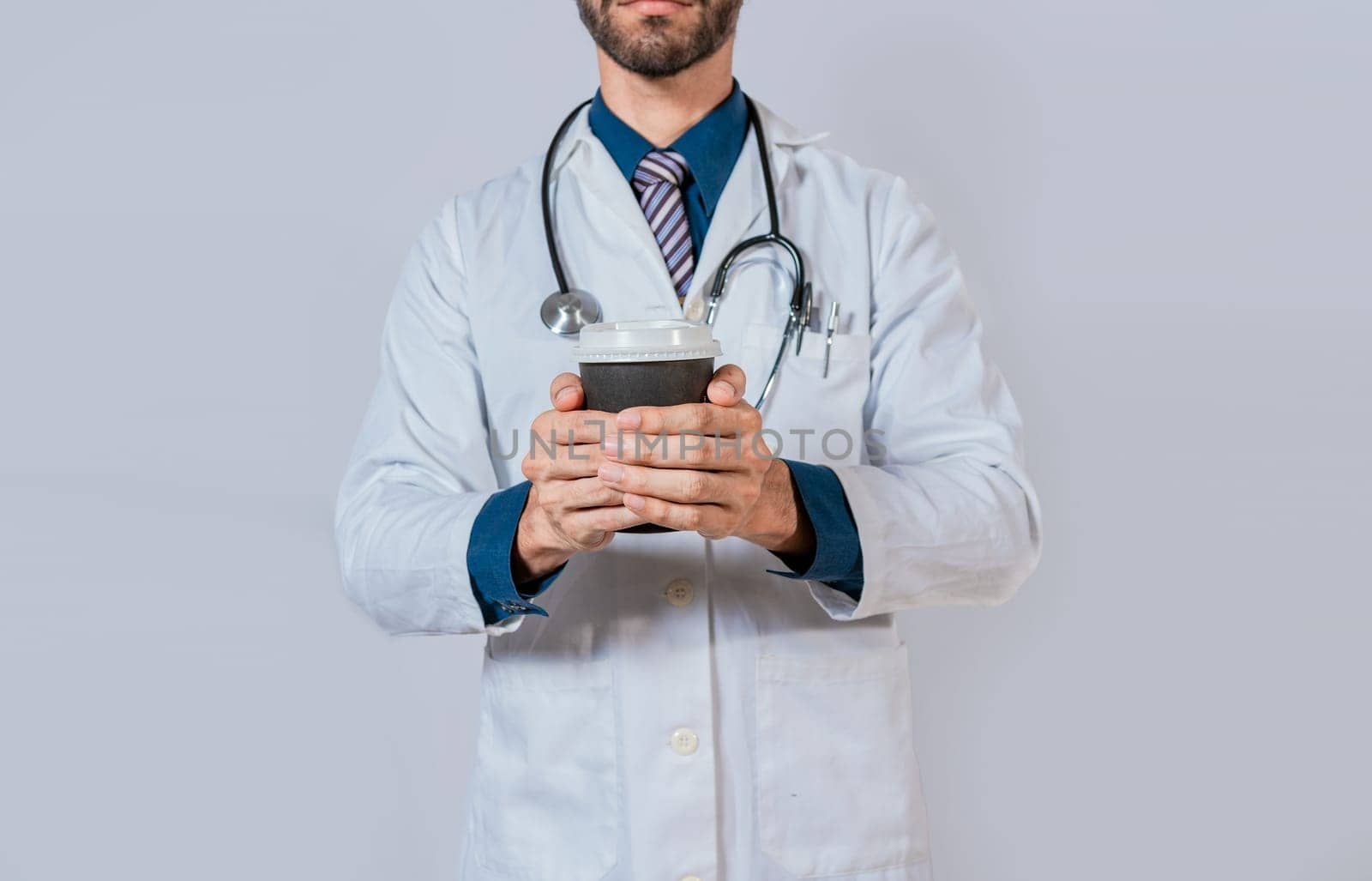 Doctor hands holding paper coffee. Doctor holding takeaway coffee on isolated background, Young doctor holding a coffee to go isolated by isaiphoto