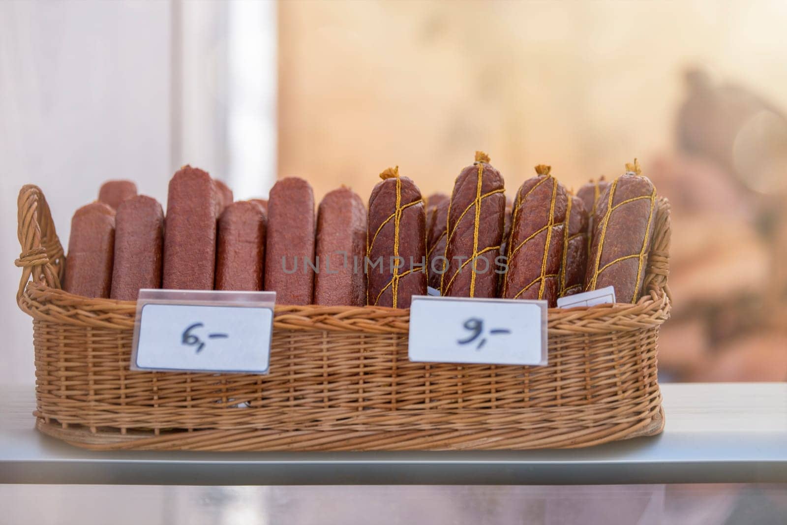 Different sausages lies in a basket. Sausages are made from meat. by SERSOL