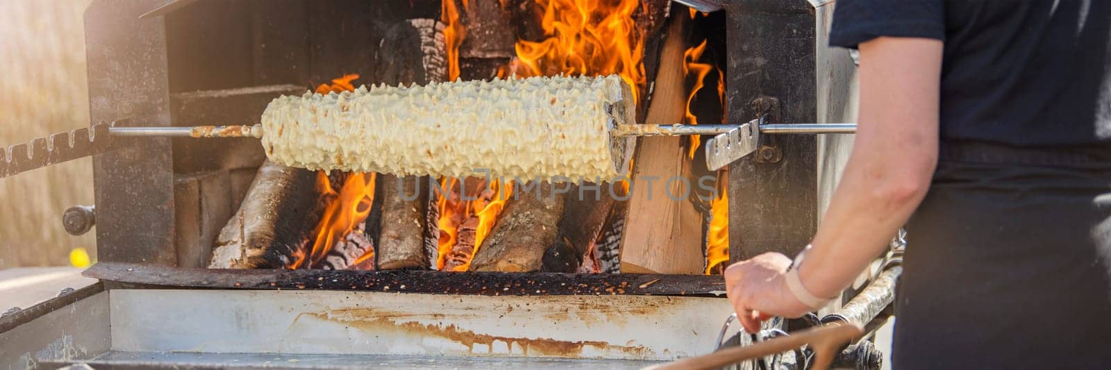 Baumkuchen baking. Making a puff traditional Lithuanian pie in the oven - Shakotis or Spruce pie. High quality photo