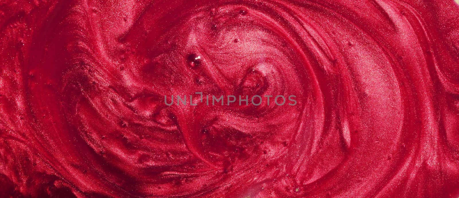 Sample of red glitter gel with small particles, texture of highlighter cosmetics, lipstick, blush