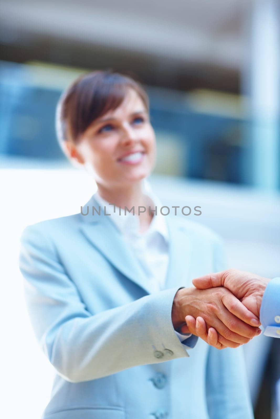 Youve got yourself a deal. two people shaking hands in a corporate environment. by YuriArcurs