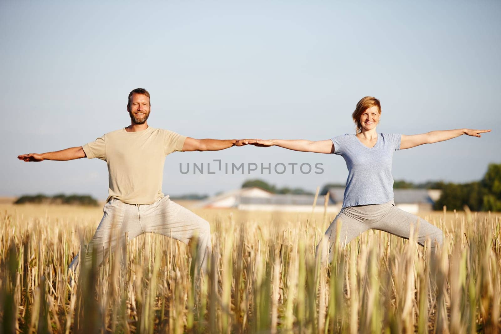 Living a healthy lifestyle together. Portrait of a mature couple enjoying a yoga workout in a crop field