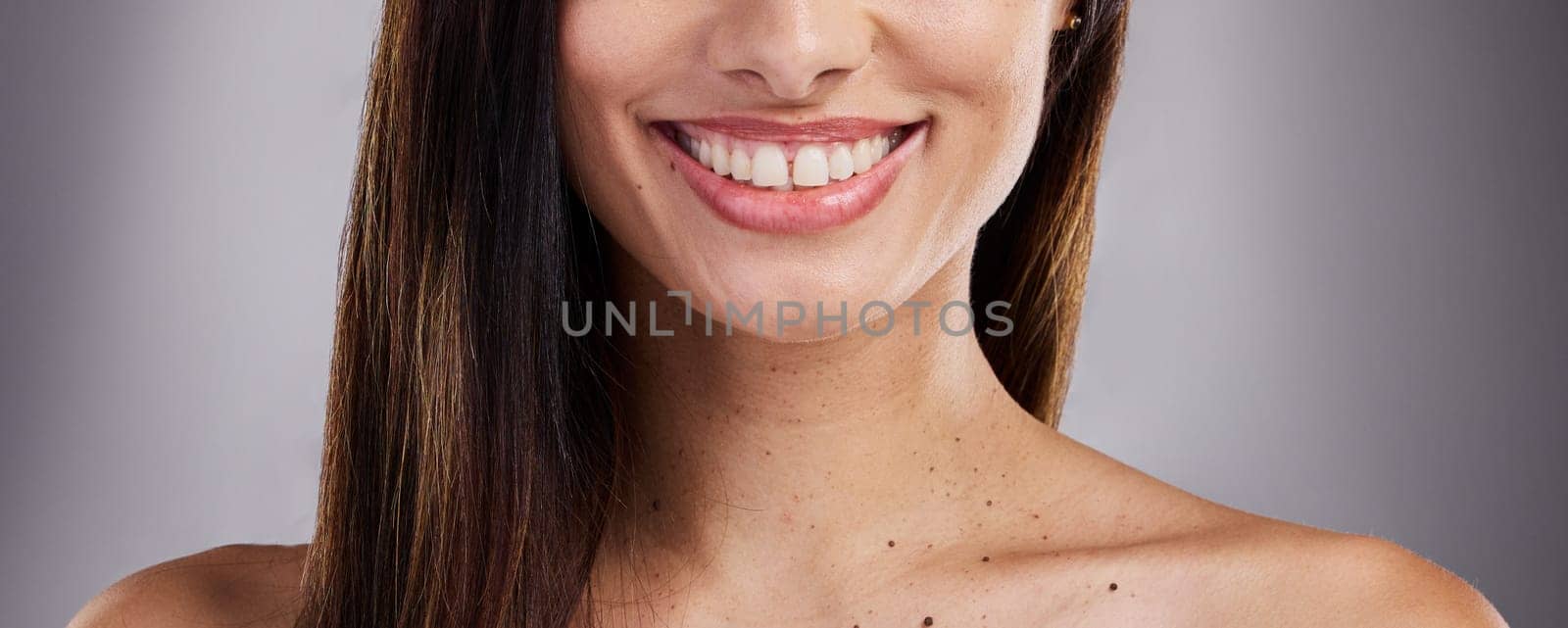 Dental, care and woman with a smile for teeth, healthcare and the dentist against a grey studio background. Happy, excited and girl model with medical cosmetics for cleaning of mouth for wellness by YuriArcurs