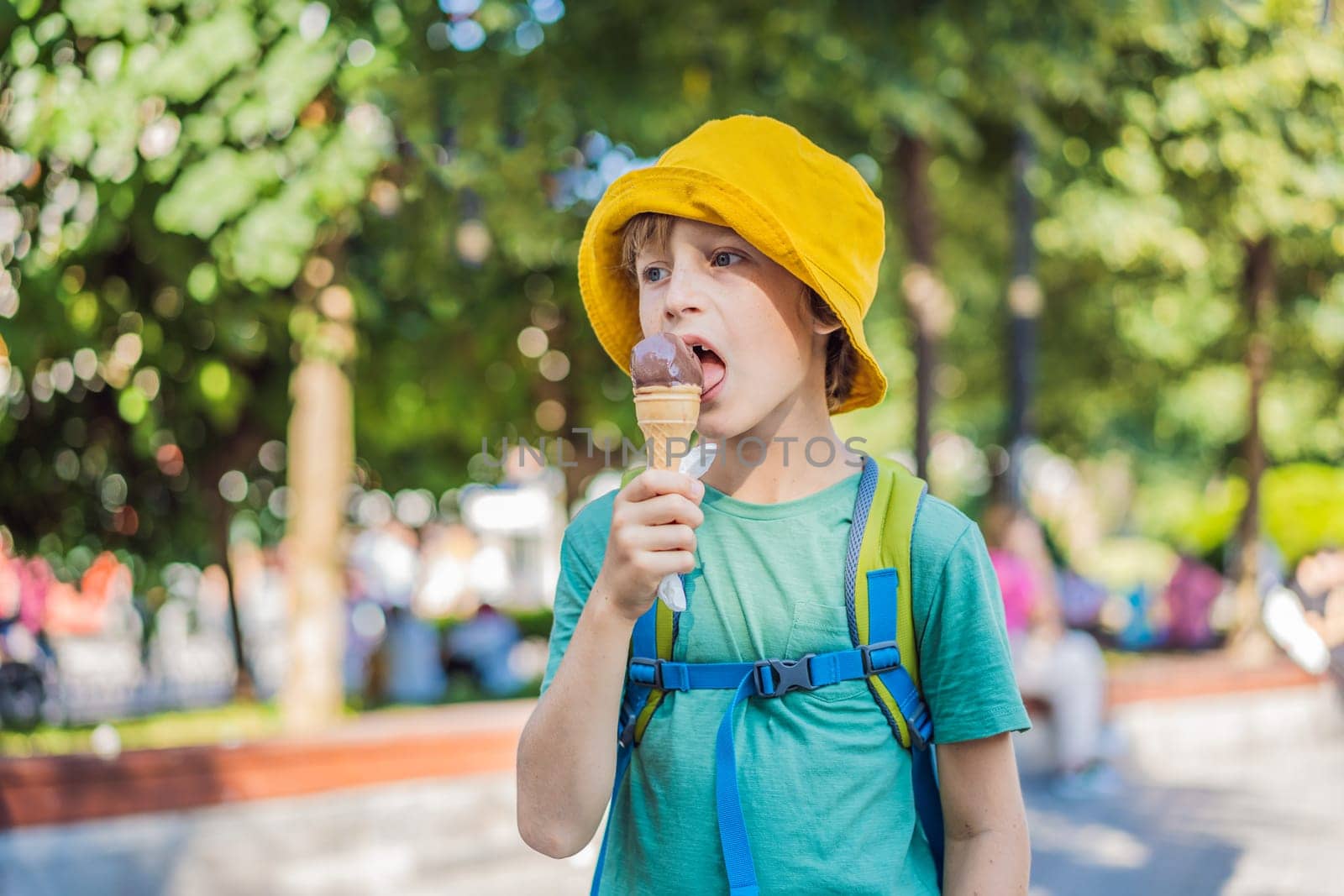 Boy tourist boy eating turkish ice cream.