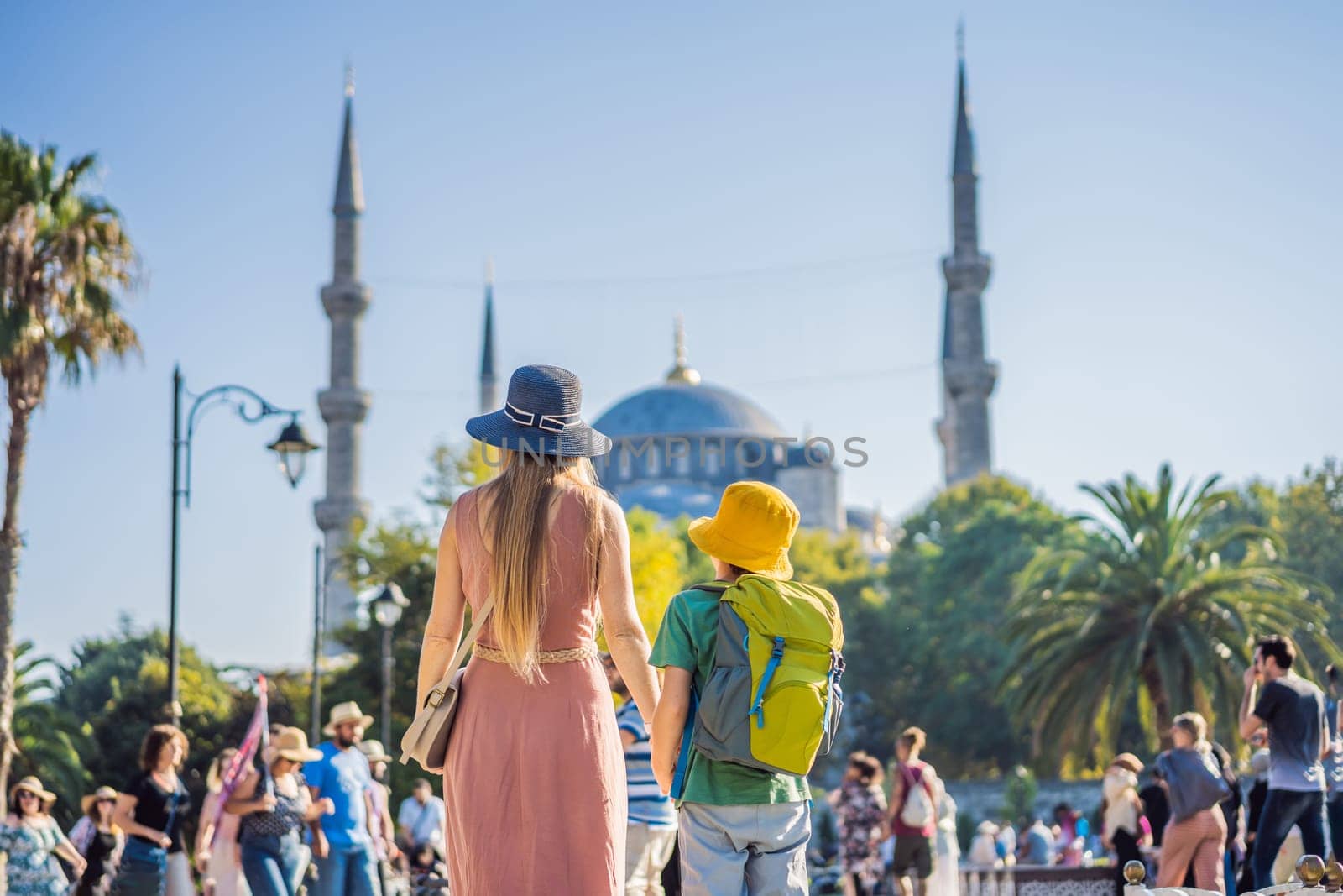 Mother and son tourists enjoying the view Blue Mosque, Sultanahmet Camii, Istanbul, Turkey. Traveling with kids concept by galitskaya