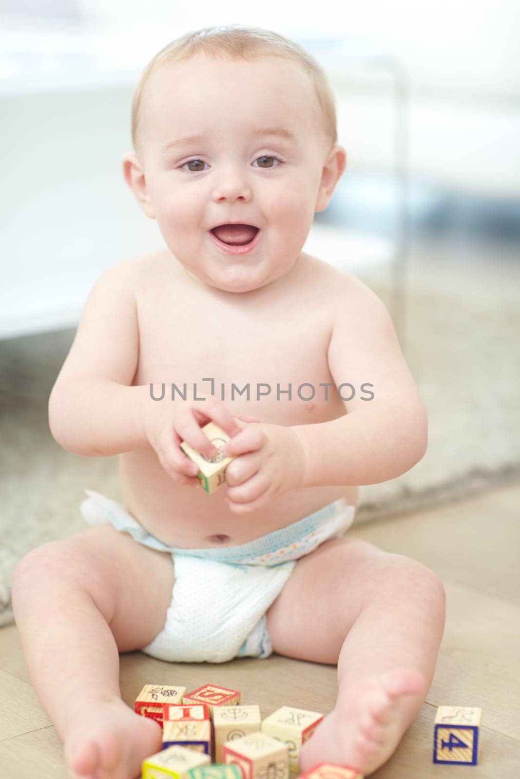 Im so excited and I just cant hide it. Portrait of an adorable little boy wearing his diaper while playing with his blocks