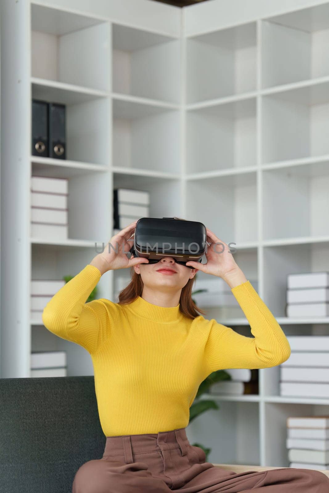 Attractive Asian woman resting comfortable living room and using AR glasses, Relax, Sofa, Lifestyle, Virtual Reality Headset.