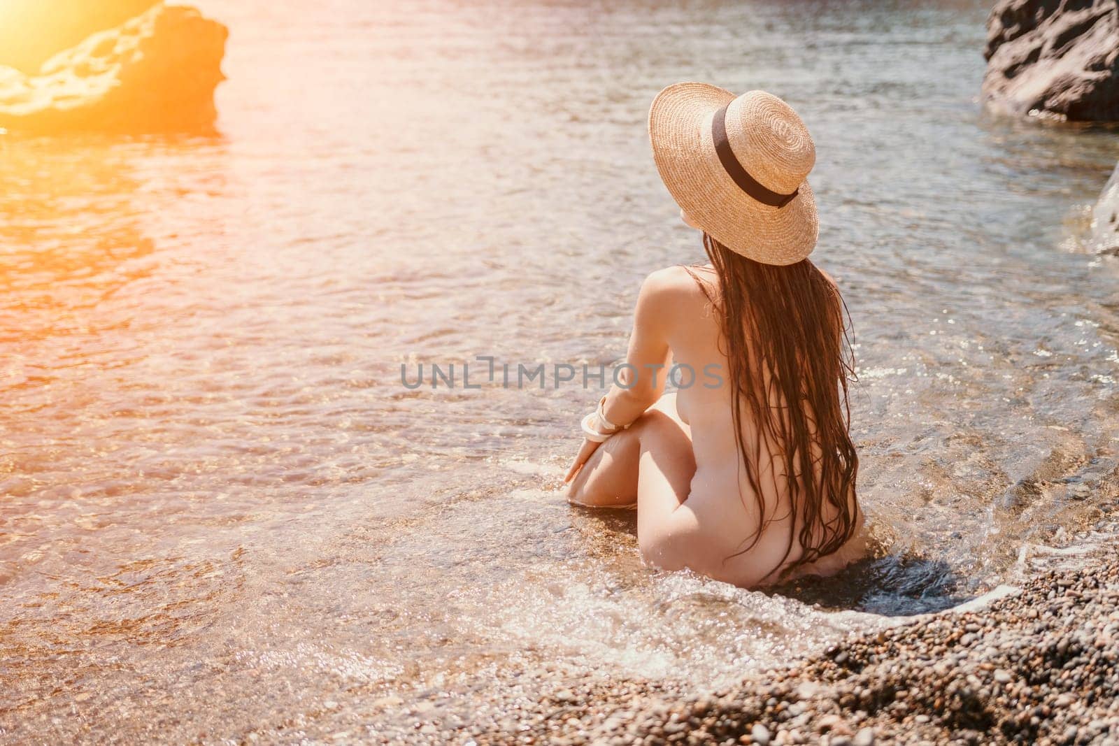 Woman travel sea. Happy tourist taking picture outdoors for memories. Woman traveler looks at the edge of the cliff on the sea bay of mountains, sharing travel adventure journey.