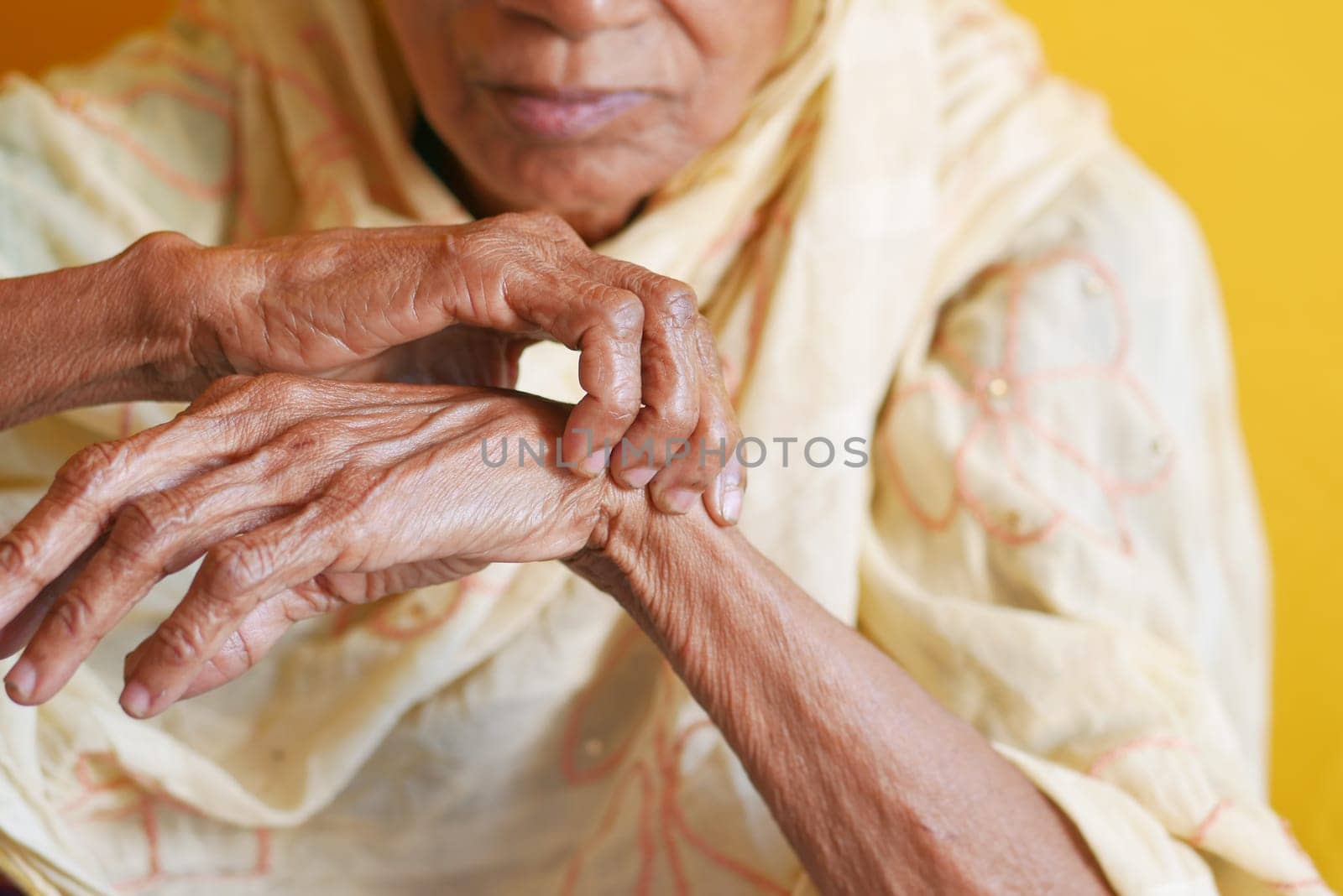 Elderly woman suffering from pain .