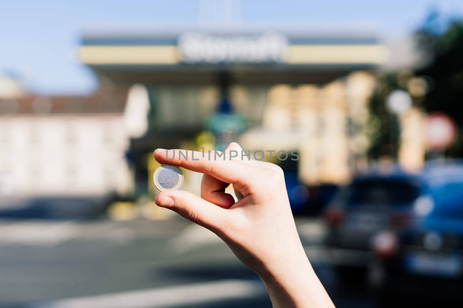 Euro coin and refueling of a car at a gas station in city, expensive fuel oil by Zelenin