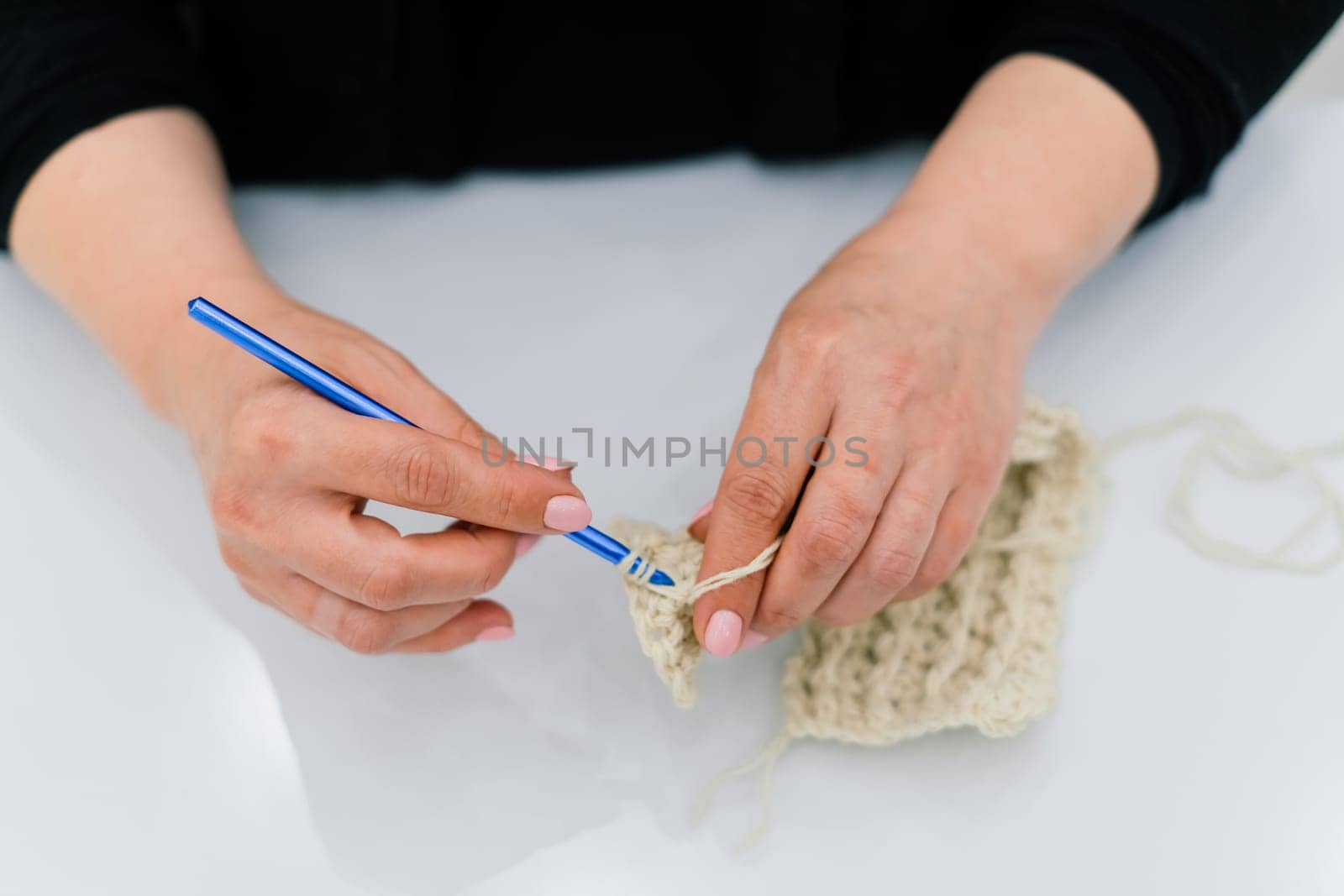 Process of knitting isolated on white, female hands by Zelenin