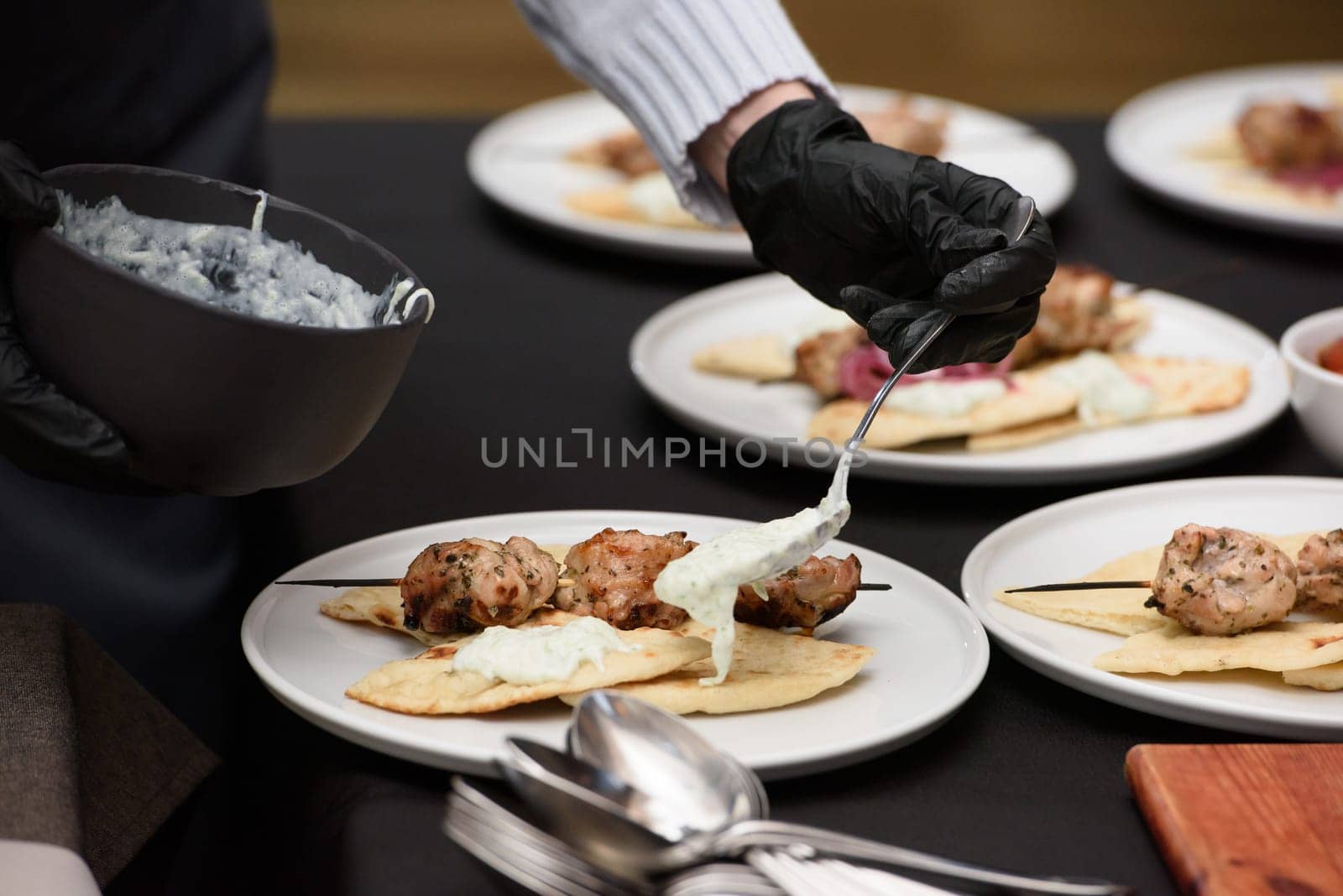 Greek food. souvlaki wrapped in a pita bread on a white plate