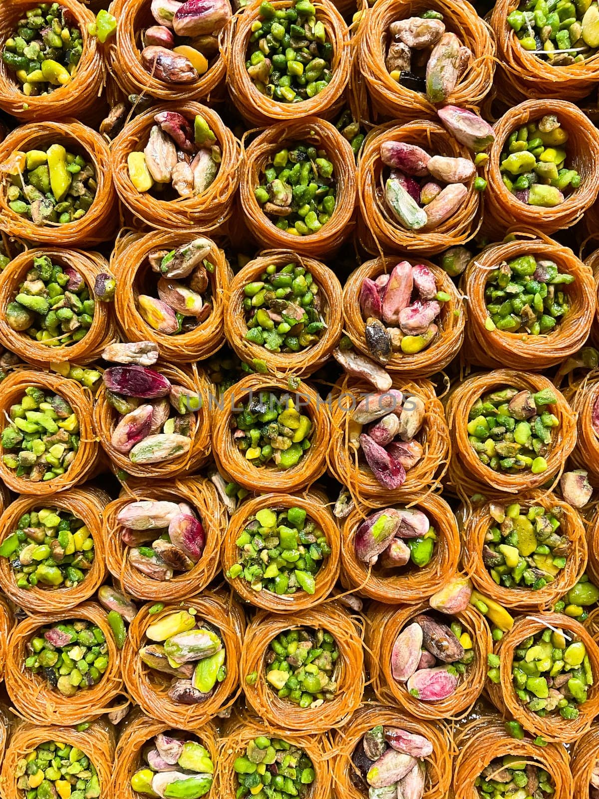 Oriental sweets close-up. Baklava with pistachios, walnuts, almonds. Photo for puzzles, postcards, articles, books.