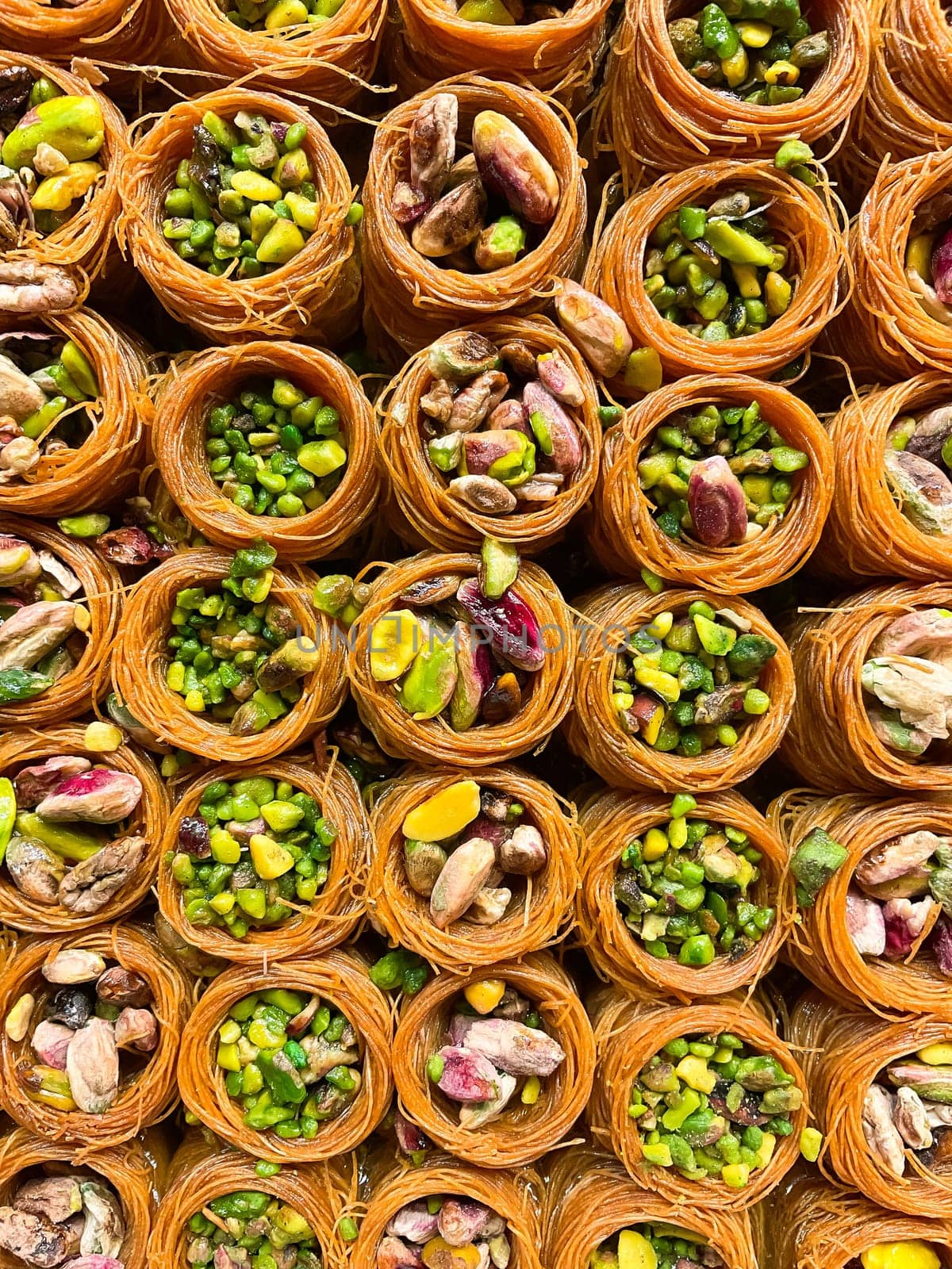 Oriental sweets close-up. Baklava with pistachios, walnuts, almonds. Photo for puzzles, postcards, articles, books.