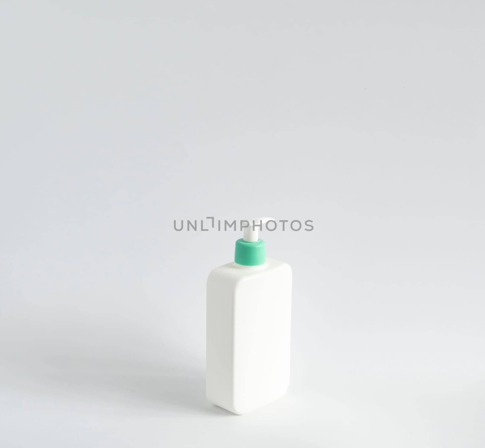 White unbranded dispenser shampoo, gel, soap bottle isolated on white background. Cosmetic packaging mockup with copy space