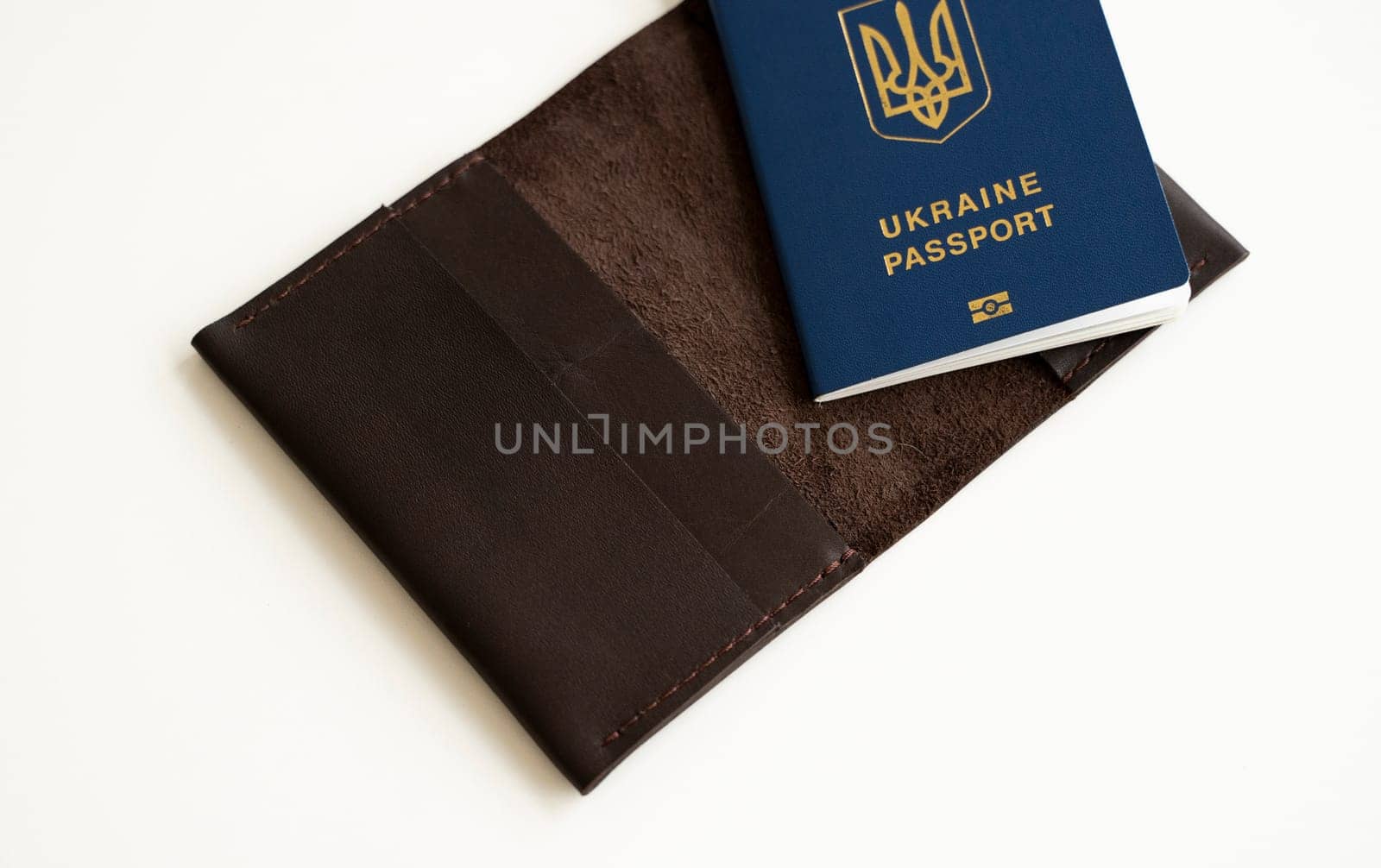 Ukrainian passport with a leather cover on a white background, selective focus. Inscription in Ukrainian Ukraine Passport