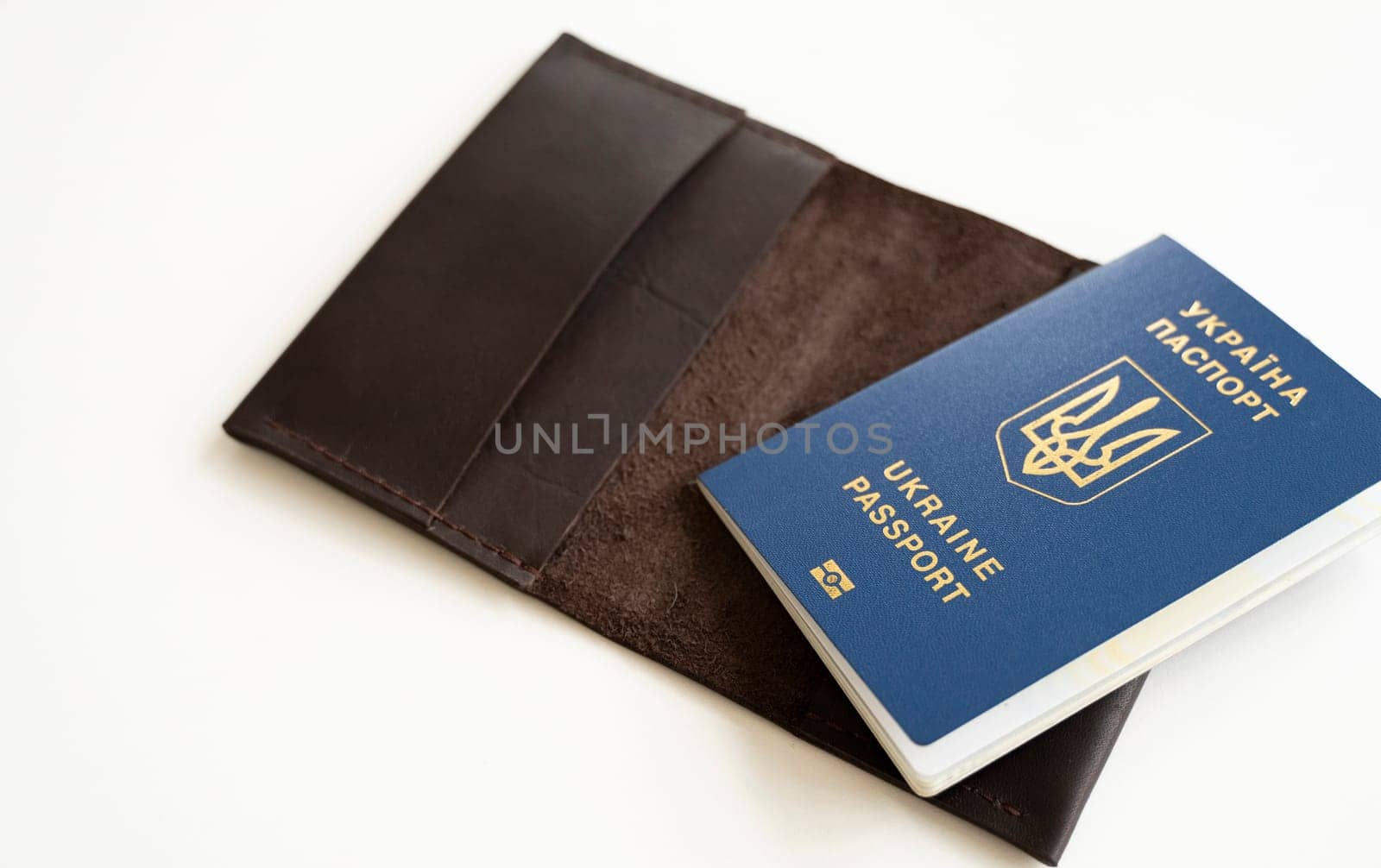Ukrainian passport with a leather cover on a white background, selective focus. Inscription in Ukrainian Ukraine Passport