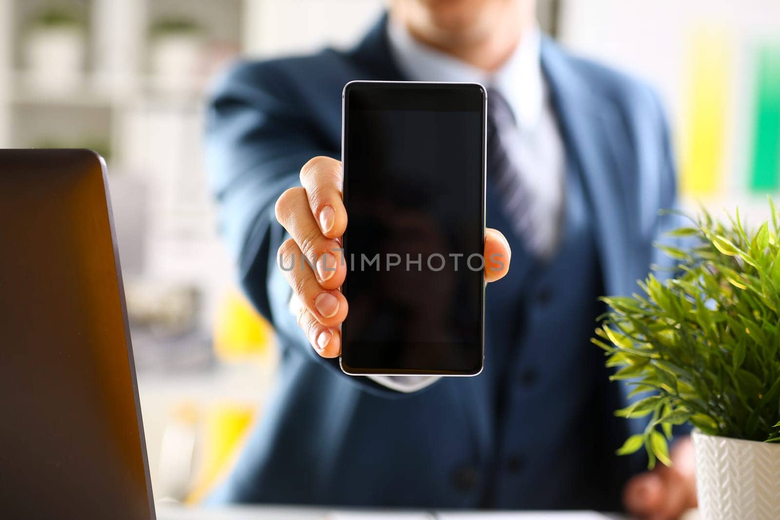 Male arm in suit show in camera phone display screen closeup. Read news mania send sms chat addict use electronic bank modern lifestyle job plan colleague share blog tweet web application search