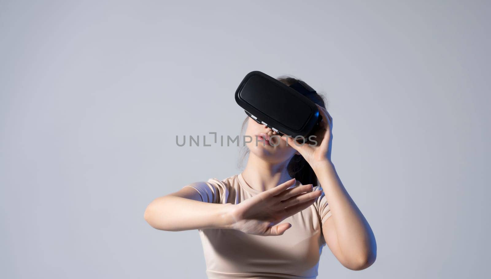 Technology, innovation gadgets. Brunette woman using virtual reality glasses.Virtual gadgets for entertainment, work, free time and study. Playing with VR. by vovsht