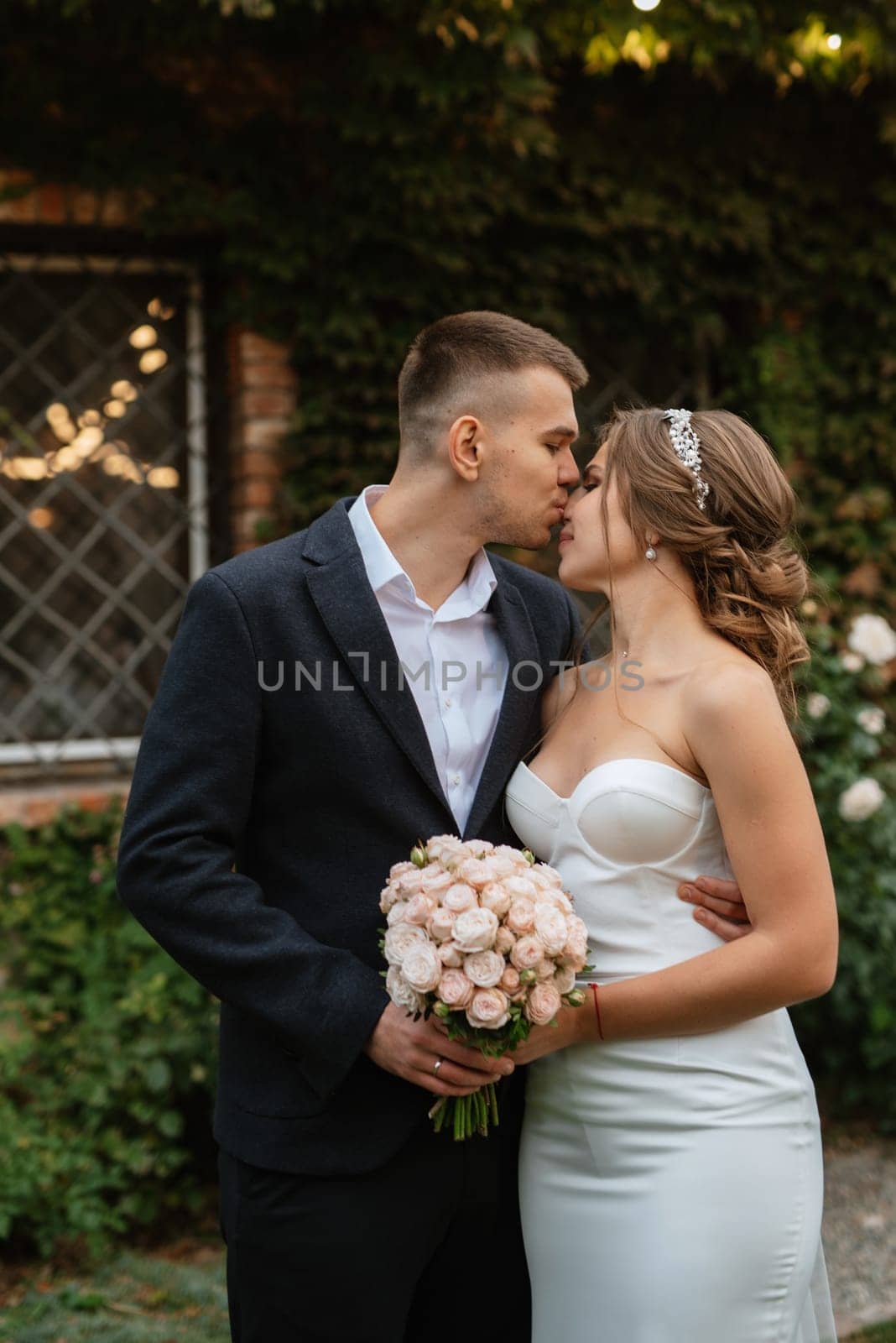 portrait of a young couple of bride and groom on their wedding day in a country cottage