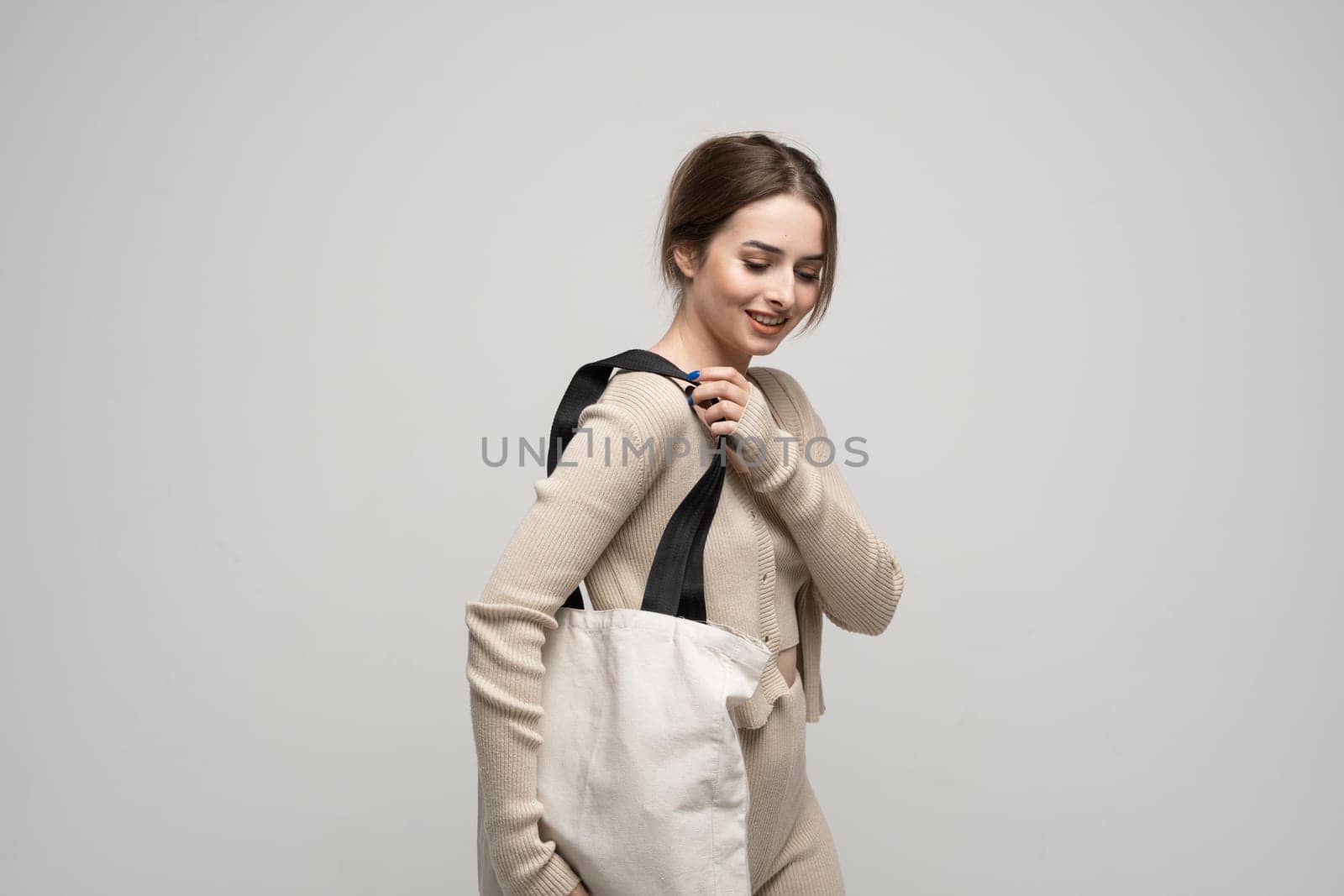 Young woman with cotton bag in her hands. Concept of recycle for better environment. No plastic