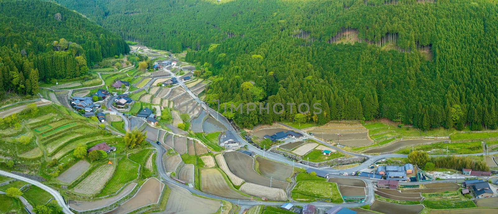 Panoramic aerial view of terraced rice fields in remote mountain village. High quality photo