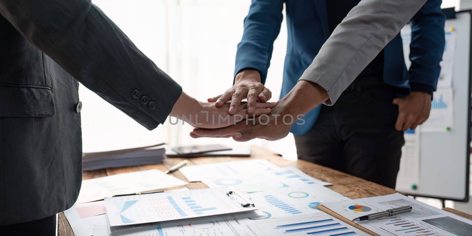 Business teamwork join hands together. group of young people putting their hands. Teamwork Join Hands Support Together Concept. by nateemee