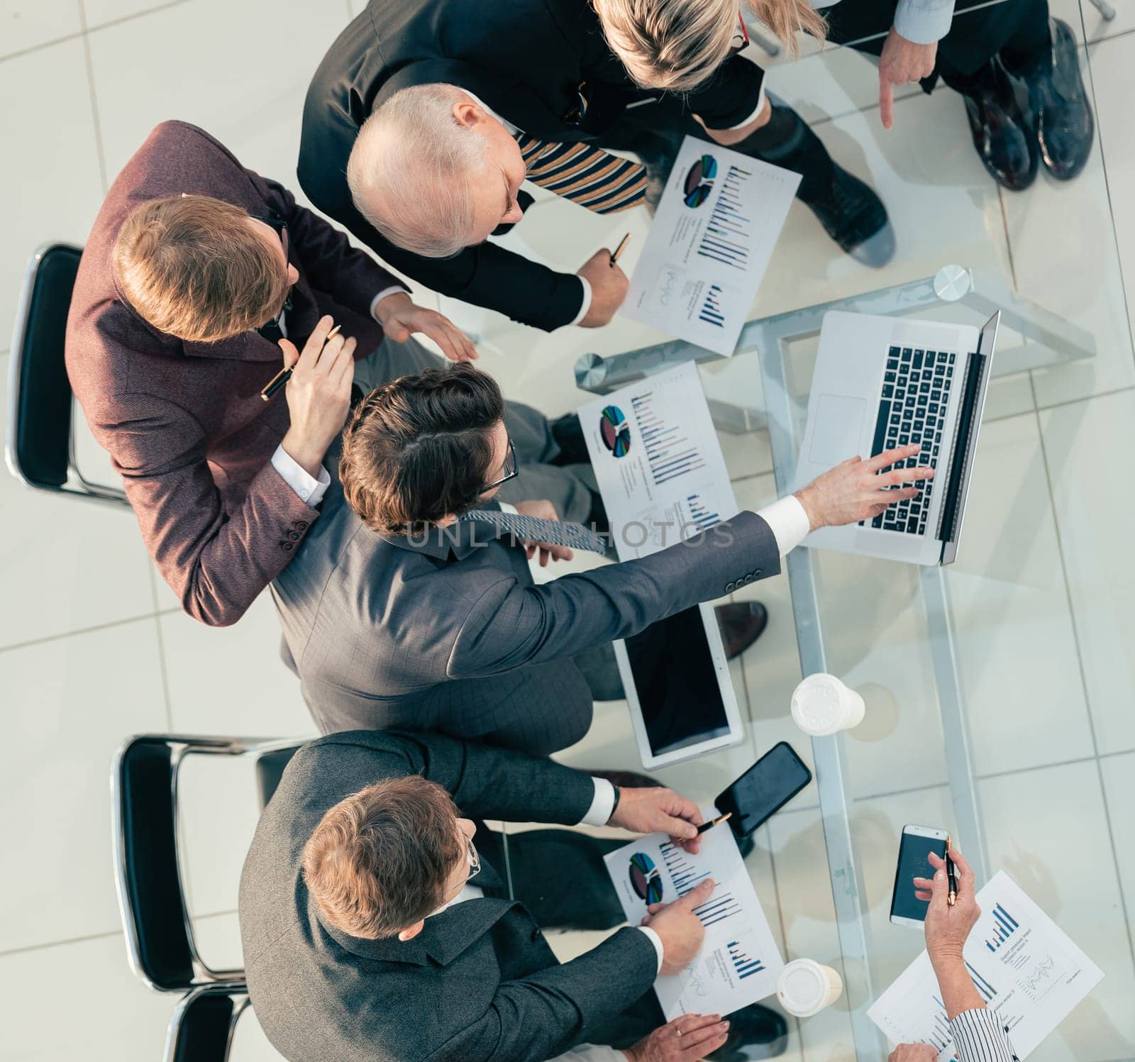 top view. working group discussing financial reports at an office meeting . business concept.