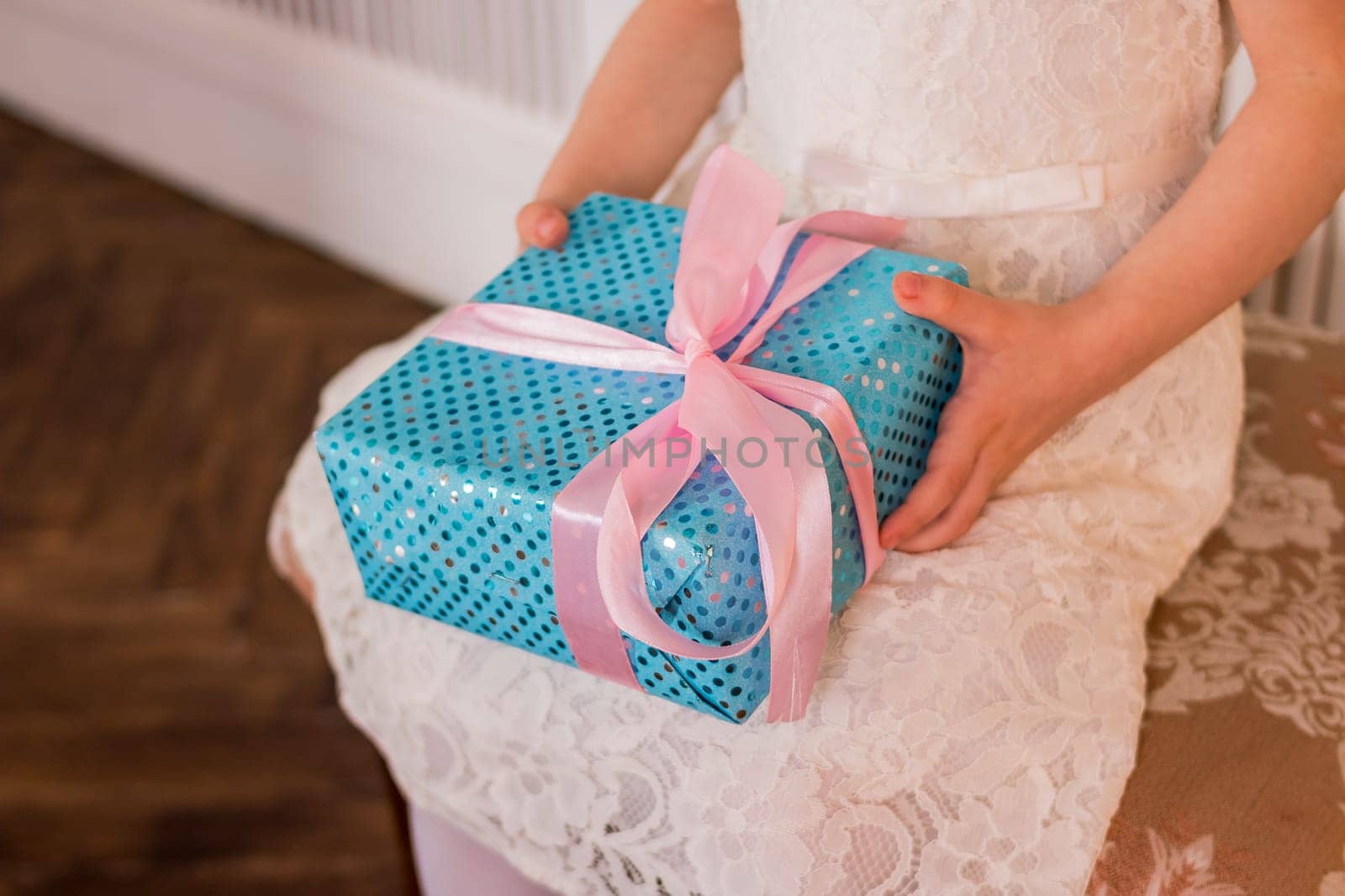 Female hands holding gift box. Copy space. Christmas, hew year, birthday concept. Festive background with bokeh and sunlight. Magic fairy tale