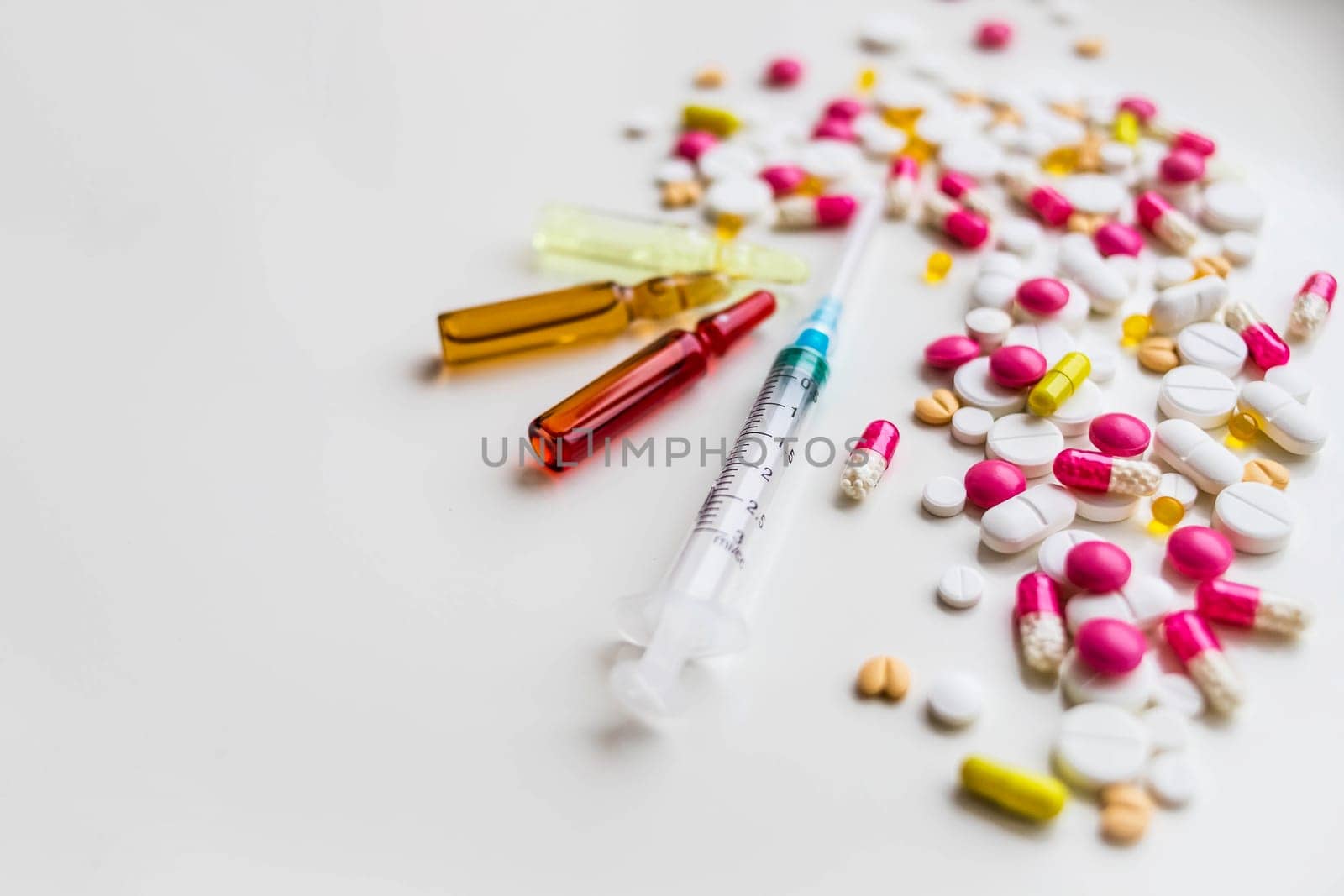 Medical colorful vials for injection syringe and red heart on a white background. Healthy heart.