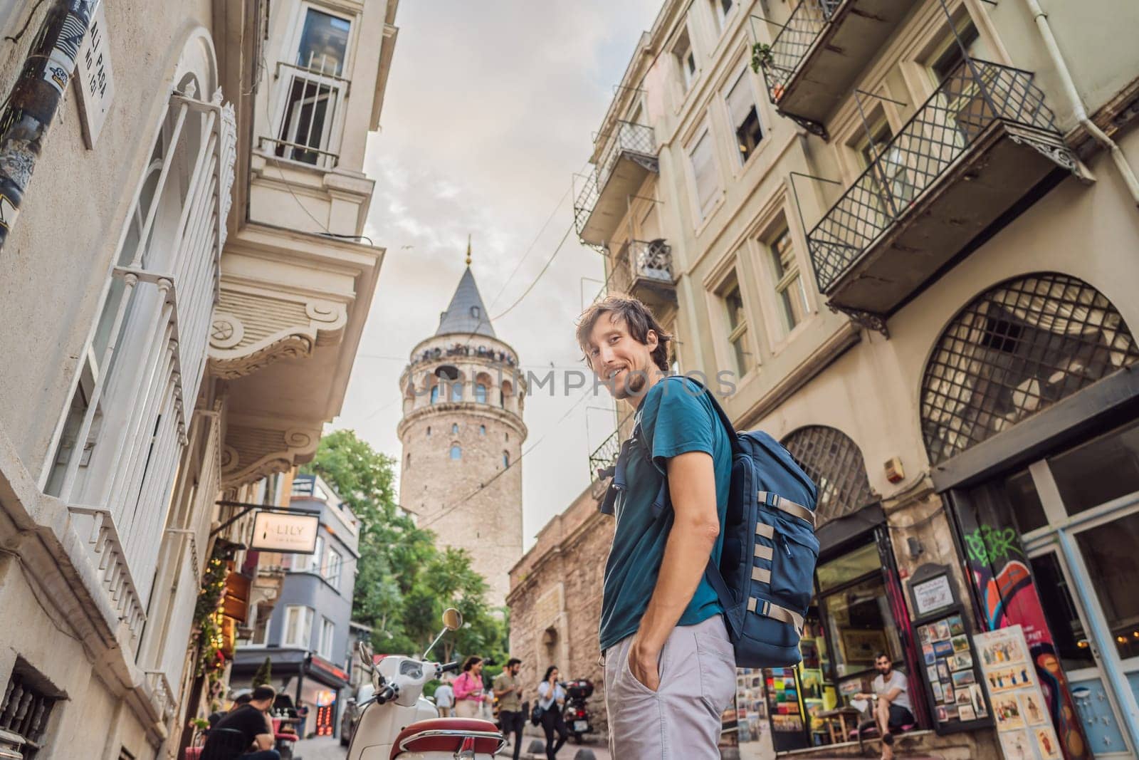 Portrait of man tourist with view of Galata tower in Beyoglu, Istanbul, Turkey. Turkiye.