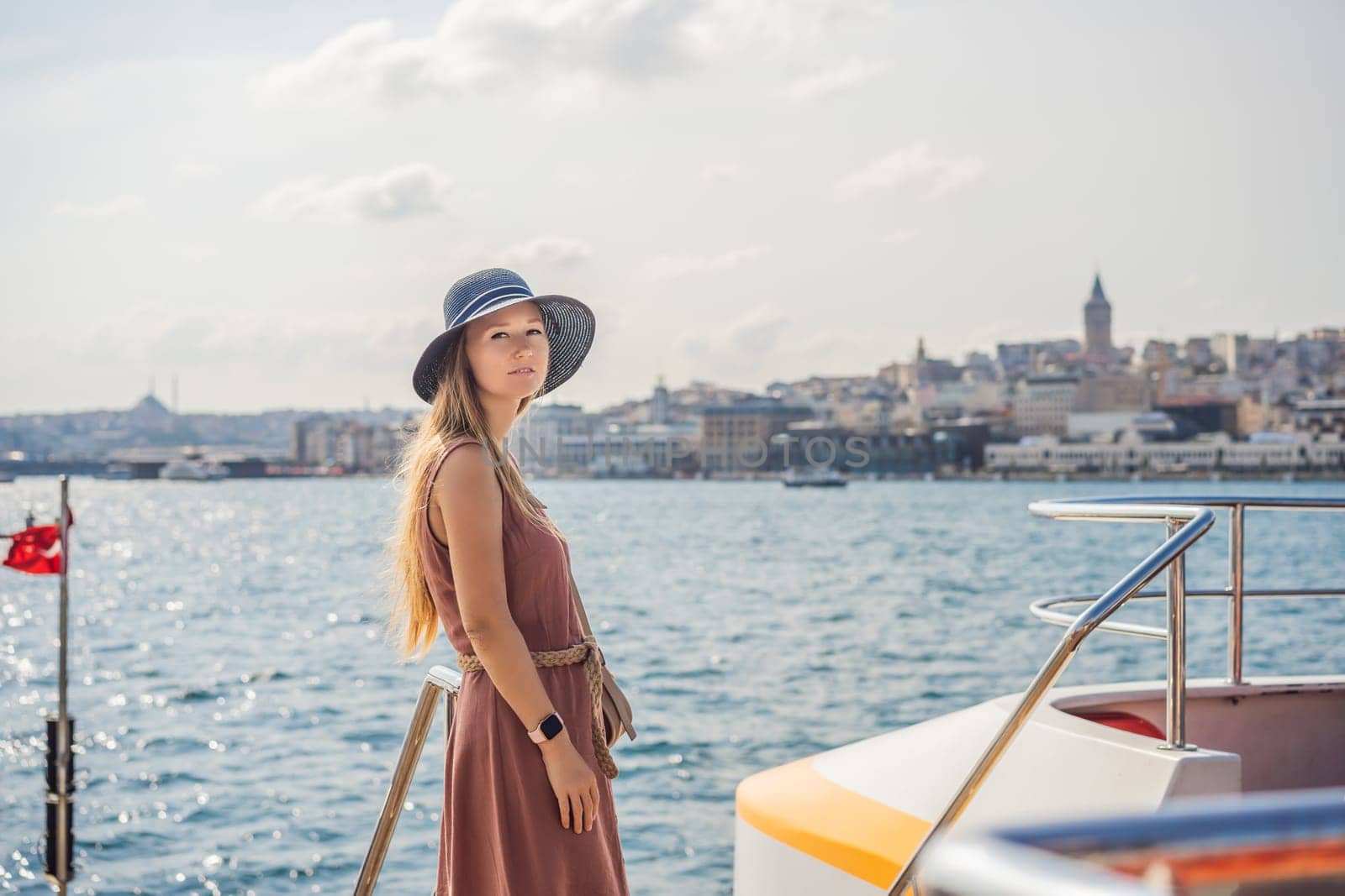 Portrait of beautiful woman tourist with view of Galata tower in Beyoglu, Istanbul, Turkey. Turkiye.