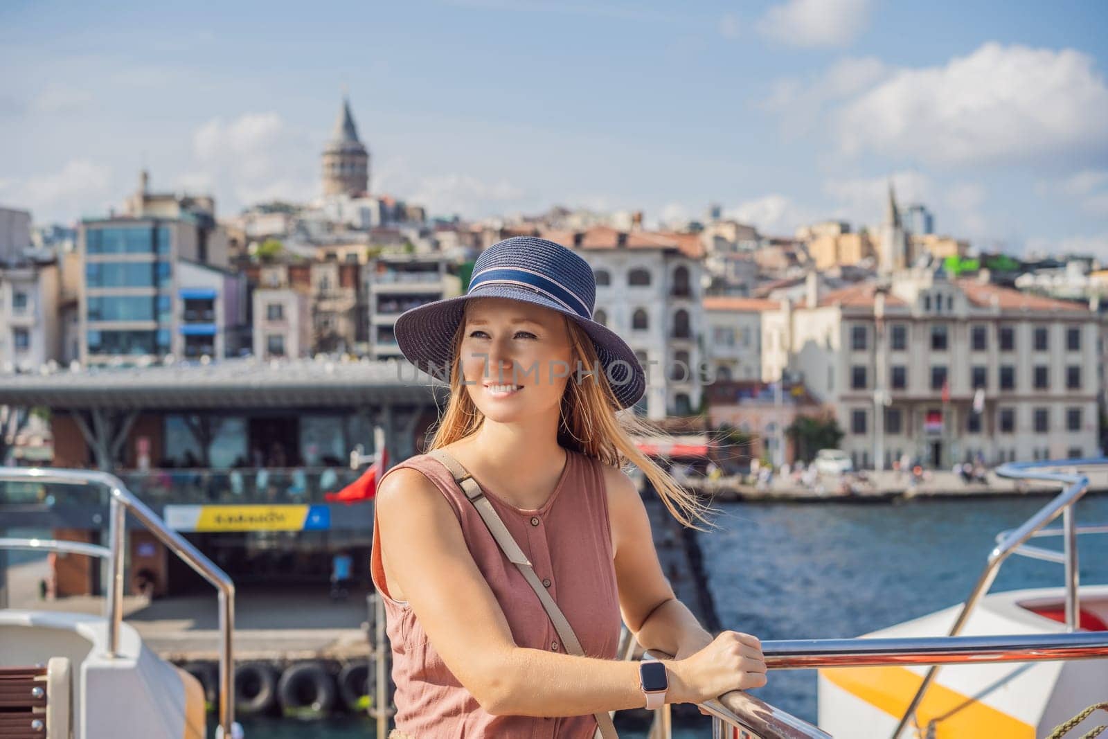 Happy woman enjoying the sea from ferry boat crossing Bosphorus in Istanbul. Summer trip to Istanbul.